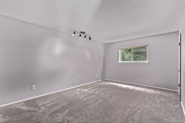 2212 S Naples Way, Aurora, CO 80013 - empty room featuring carpet floors, a textured ceiling, and track lighting