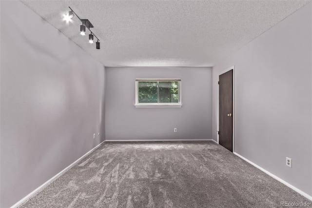 2212 S Naples Way, Aurora, CO 80013 - carpeted spare room featuring a textured ceiling and baseboards