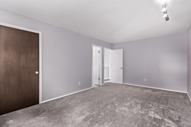 2212 S Naples Way, Aurora, CO 80013 - unfurnished bedroom featuring carpet floors and a textured ceiling