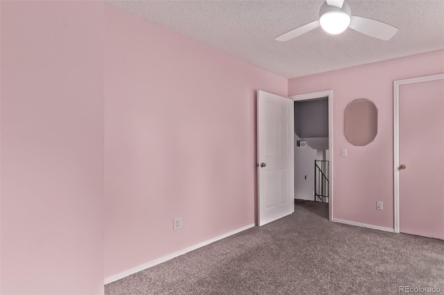 2212 S Naples Way, Aurora, CO 80013 - spare room featuring dark colored carpet, ceiling fan, and a textured ceiling