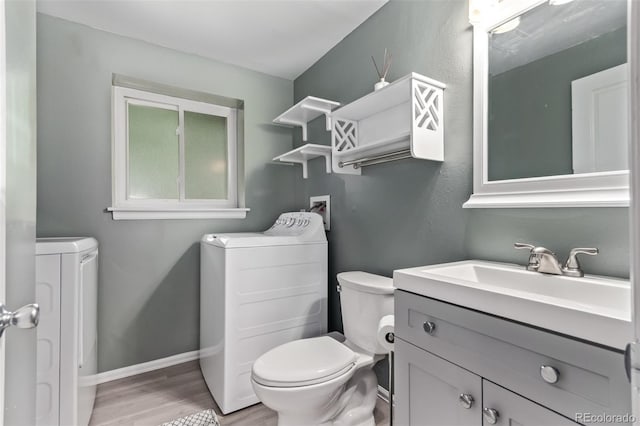 2212 S Naples Way, Aurora, CO 80013 - bathroom with separate washer and dryer, wood finished floors, and vanity