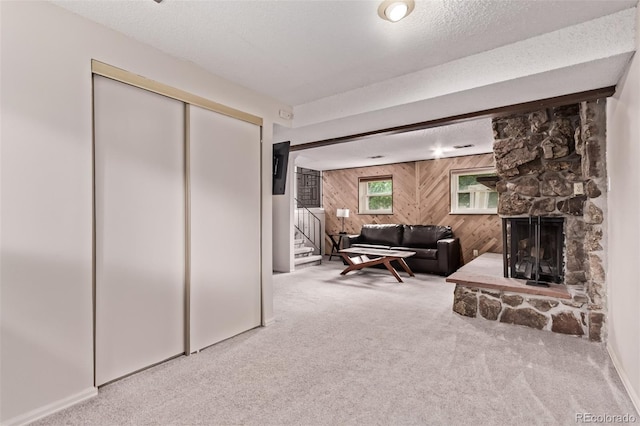 2212 S Naples Way, Aurora, CO 80013 - carpeted living room featuring wood walls, stairs, and a fireplace