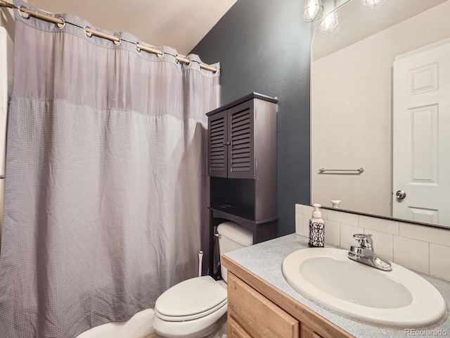 bathroom featuring vanity, a shower with shower curtain, backsplash, and toilet