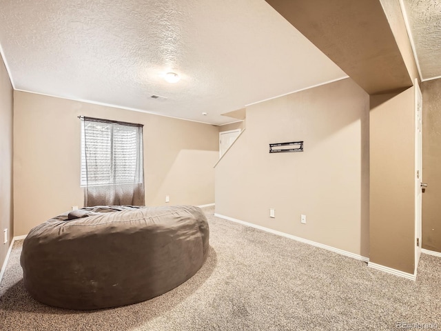 sitting room featuring carpet floors and a textured ceiling