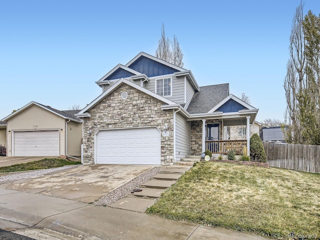 view of front of property featuring a porch, a garage, and a front lawn