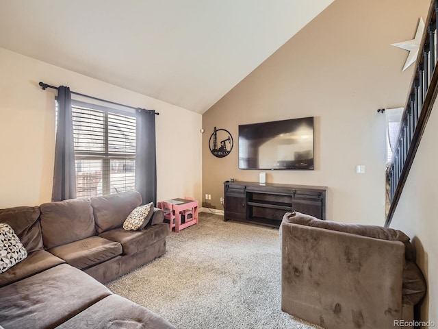 carpeted living room featuring lofted ceiling