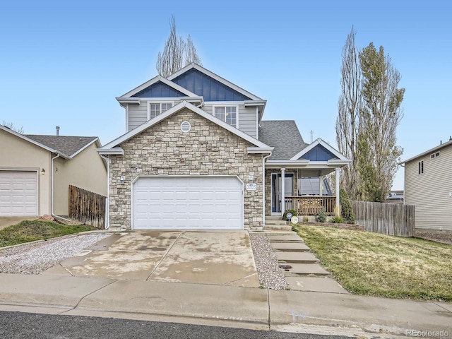 view of front of home with a porch, a garage, and a front yard