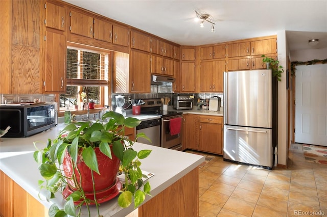 kitchen featuring backsplash, stainless steel appliances, and light tile patterned flooring