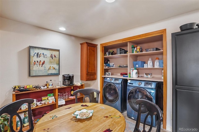 clothes washing area featuring laundry area and washing machine and clothes dryer