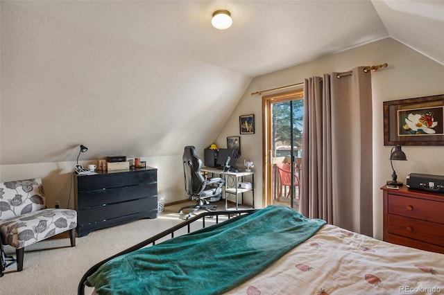 bedroom with access to exterior, vaulted ceiling, and carpet flooring