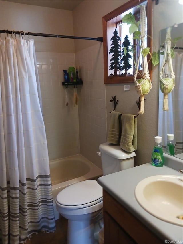 bathroom featuring vanity, shower / bath combination with curtain, and toilet