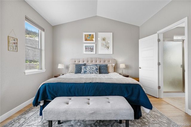 bedroom with light wood-style floors, baseboards, and vaulted ceiling