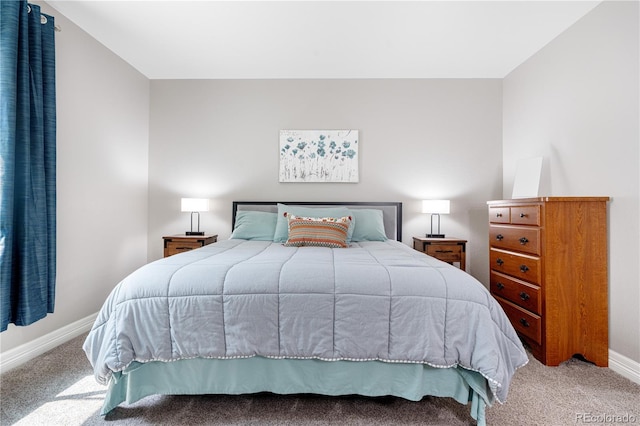 bedroom with baseboards and carpet