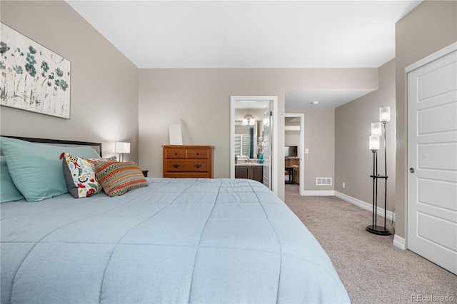 bedroom featuring carpet floors, baseboards, visible vents, and ensuite bathroom