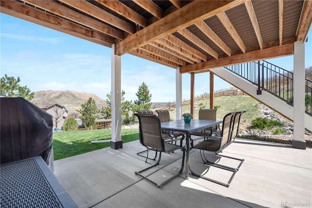view of patio / terrace featuring outdoor dining area and a mountain view