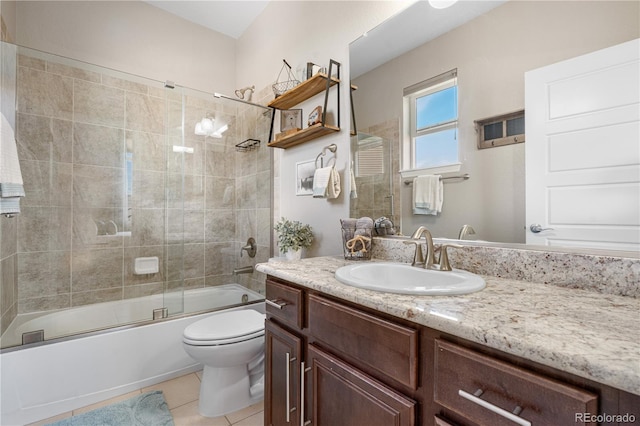 full bathroom featuring tile patterned flooring, shower / bath combination with glass door, toilet, and vanity