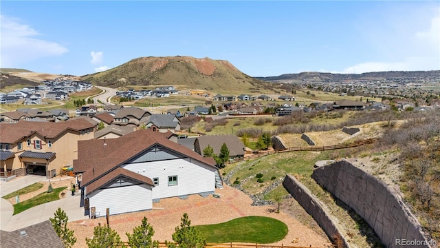 drone / aerial view featuring a residential view and a mountain view