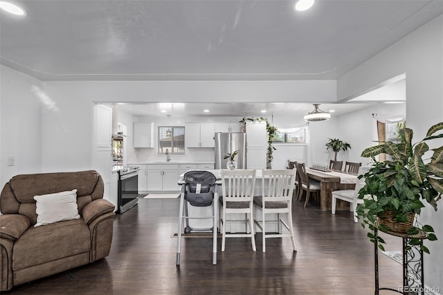 dining space featuring dark wood-style flooring and recessed lighting