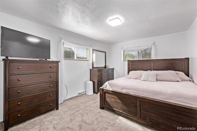 bedroom featuring visible vents and light carpet