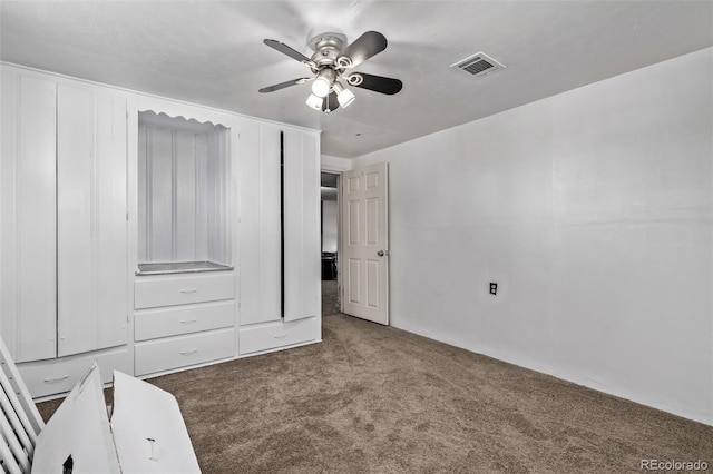 unfurnished bedroom with visible vents, carpet, and ceiling fan