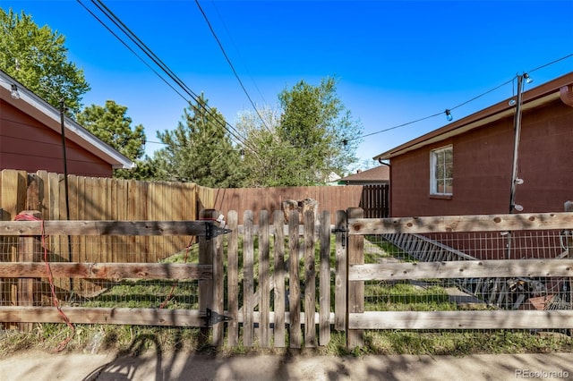 view of yard featuring fence and a gate