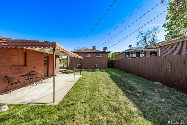 view of yard with fence and a patio