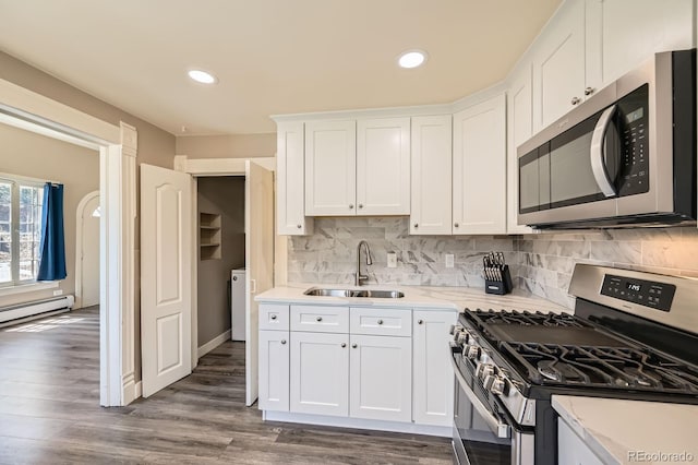 341 High St, Black Hawk, CO 80422 - kitchen with appliances with stainless steel finishes, a sink, light countertops, white cabinetry, and decorative backsplash