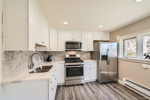 341 High St, Black Hawk, CO 80422 - kitchen featuring appliances with stainless steel finishes, a baseboard radiator, a sink, white cabinets, and light wood finished floors