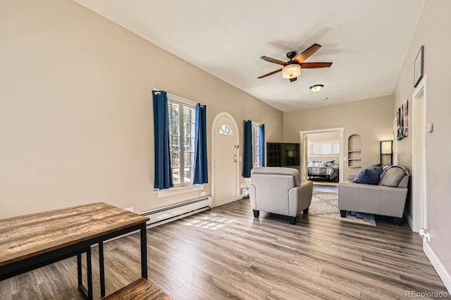341 High St, Black Hawk, CO 80422 - living room with a baseboard heating unit, ceiling fan, wood finished floors, and healthy amount of natural light