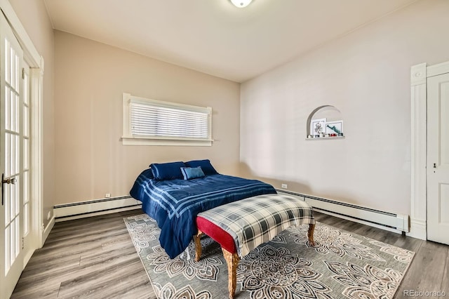 341 High St, Black Hawk, CO 80422 - bedroom featuring baseboard heating and wood finished floors