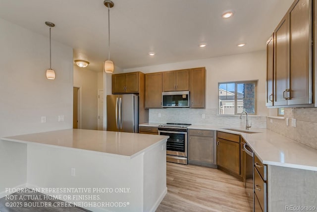 881 W 128th Pl, Westminster, CO 80234 - kitchen with appliances with stainless steel finishes, backsplash, light wood-type flooring, light countertops, and recessed lighting