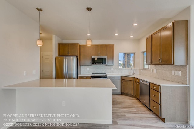 881 W 128th Pl, Westminster, CO 80234 - kitchen featuring stainless steel appliances, light wood-style flooring, decorative backsplash, a peninsula, and light countertops