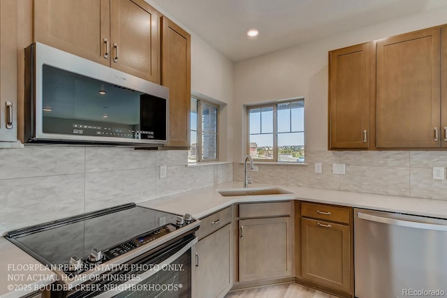 881 W 128th Pl, Westminster, CO 80234 - kitchen featuring appliances with stainless steel finishes, light countertops, decorative backsplash, recessed lighting, and brown cabinets
