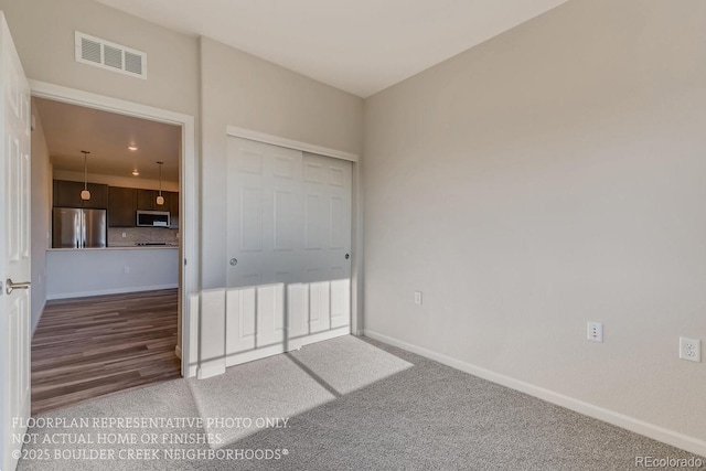 881 W 128th Pl, Westminster, CO 80234 - unfurnished bedroom featuring freestanding refrigerator and carpet floors