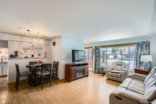273 S 13th Ave, Brighton, CO 80601 - living room with light wood-style flooring and a notable chandelier