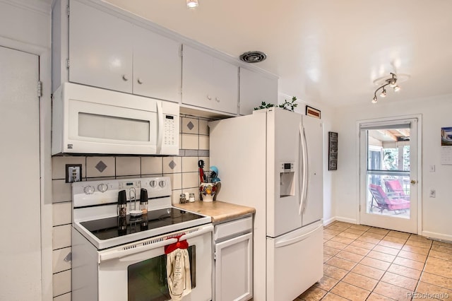 273 S 13th Ave, Brighton, CO 80601 - kitchen with light tile patterned flooring, white appliances, light countertops, baseboards, and tasteful backsplash