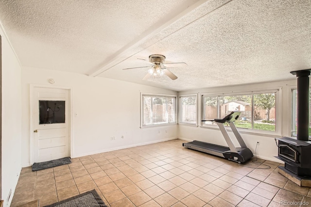 273 S 13th Ave, Brighton, CO 80601 - workout area with tile patterned floors, a textured ceiling, ceiling fan, and a wood stove