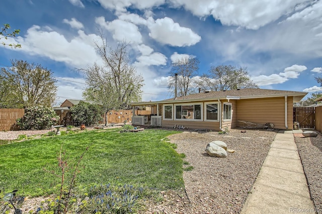 273 S 13th Ave, Brighton, CO 80601 - rear view of house with a fenced backyard, central AC unit, and a lawn