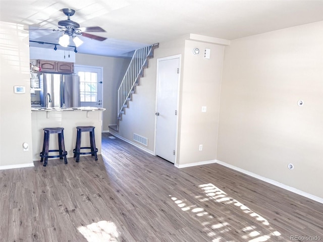 interior space featuring hardwood / wood-style flooring, sink, and ceiling fan