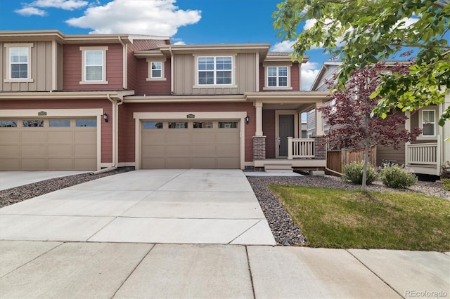 17848 Gallup St, Broomfield, CO 80023 - view of front of house featuring board and batten siding, an attached garage, driveway, and covered porch