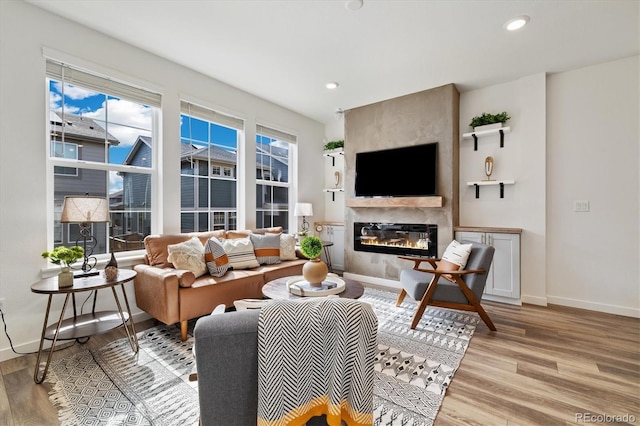 17848 Gallup St, Broomfield, CO 80023 - living room featuring light wood-style floors, a fireplace, and recessed lighting