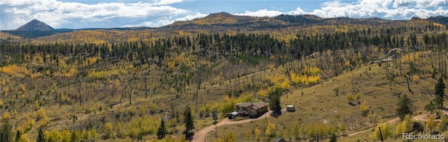 view of mountain feature with a forest view