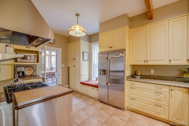 kitchen with pendant lighting, high end fridge, and island exhaust hood