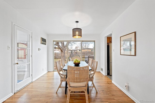 dining area with light hardwood / wood-style floors