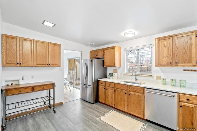 kitchen featuring sink, stainless steel appliances, and light hardwood / wood-style floors