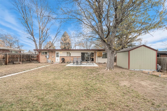 back of property with a storage unit, a patio area, and a yard