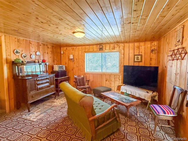 sitting room with wooden ceiling and wooden walls