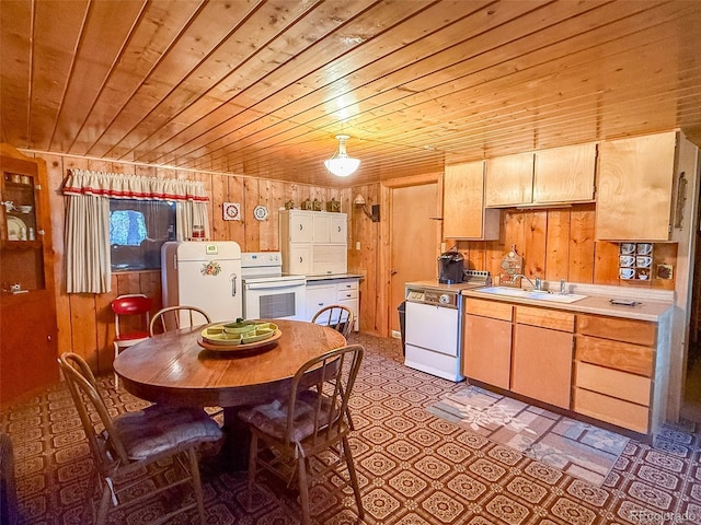 kitchen featuring sink, wood ceiling, white appliances, wooden walls, and light brown cabinetry