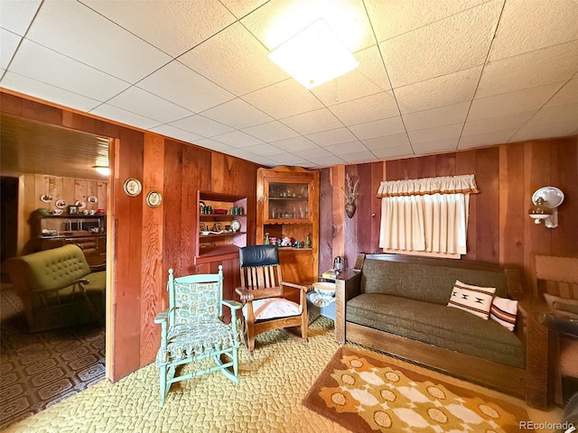 sitting room featuring wooden walls