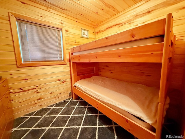 bedroom with wooden walls and wooden ceiling